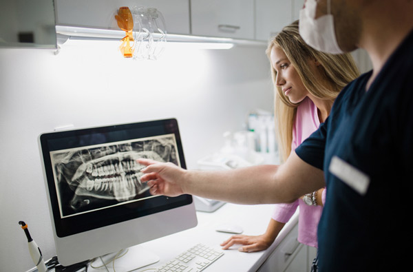 Dentist showing patient hygienist xray at Robert F. Walker Jr. DDS in Chandler, AZ