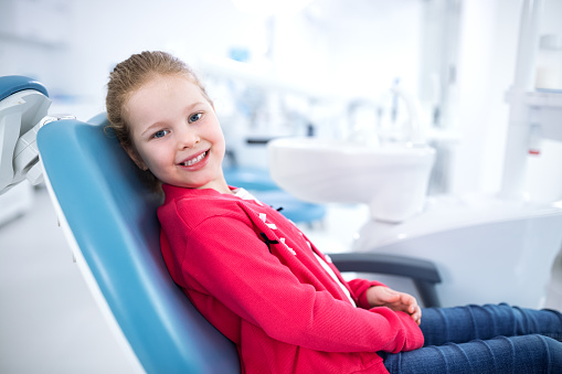 Little girl in dental chair smiling at Robert F. Walker Jr. DDS in Chandler, AZ